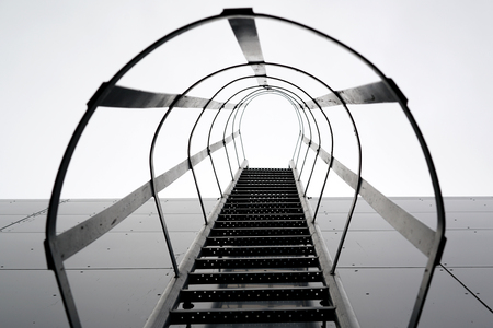 Fire escape on the glossy exterior of an industrial hallの写真素材