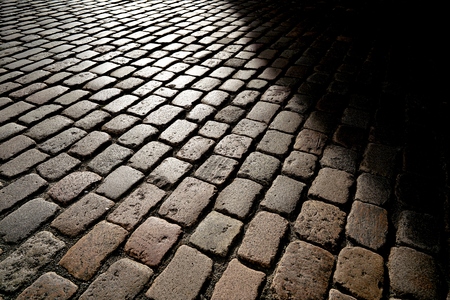 cobblestones in backlight at sunsetの写真素材