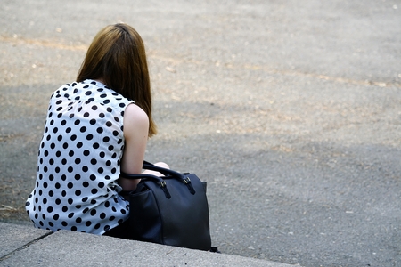 Teenager sitting on a staircaseの写真素材