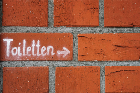 Lettering with the reference to toilets on a house wallの写真素材