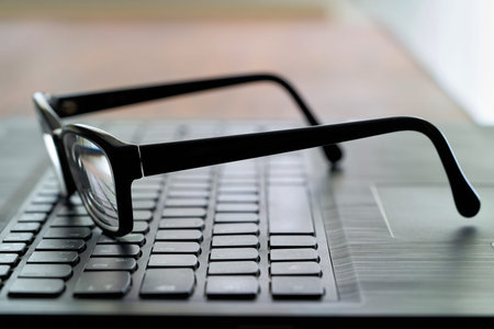 Glasses on the computer keyboard during a breakの写真素材
