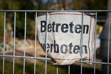 Sign on a fence with the inscription "Do not enter"の写真素材