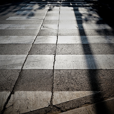 Zebra crossing in backlight in the old town of Porec in Croatiaの写真素材