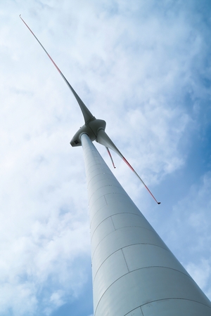 View from below of the rotor blades of a wind turbineの写真素材