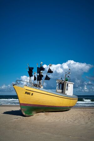 REWAL, POLAND - SEPTEMBER 02, 2019: Fishing boat on the beach at the Polish Baltic coast near Rewalのeditorial素材