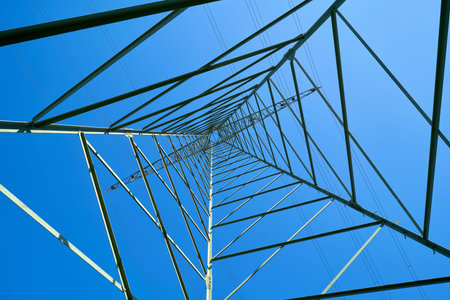 Steel construction of a power pole and blue cloudless sky
