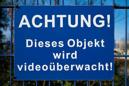 blue sign with the inscription "Attention, this object is under video surveillance"の写真素材