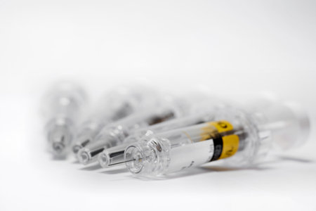 Syringe with vaccine to combat coronavirus on a tableの写真素材