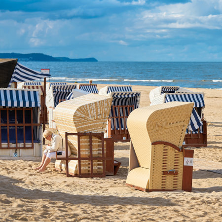 Swinoujscie, Poland - September 06, 2020: a female vacationer at a beach chair in Swinoujscie on the Polish Baltic coastのeditorial素材