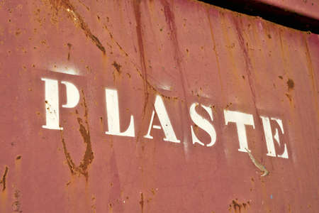 Lettering with the word Plaste (Plastic) on a container for collecting plastic waste at a disused factory in Germanyの写真素材
