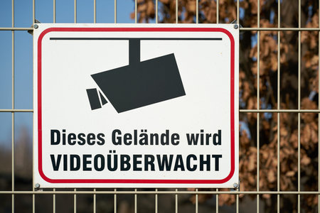 Sign on a fence with the inscription this area is under video surveillance