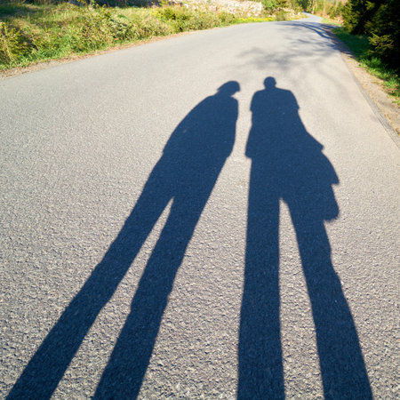 Shadow of two people on the Brocken road in the Harz National Park near Schierkeの写真素材