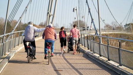 Magdeburg, Germany - February 25, 2021: Bicyclists and walkers on the Herrenkrugsteg suspension bridge on their way across the Elbe to Herrenkrugpark in Magdeburgのeditorial素材