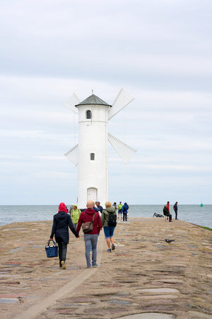 Swinoujscie, Poland - September 08, 2020: Holidaymakers at the MÃ¼hlenbake, the landmark of...