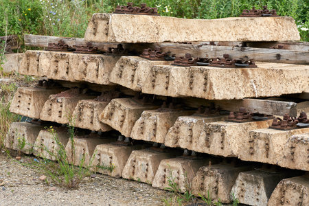 old no longer used overgrown and discarded railroad sleepers in a storage yard