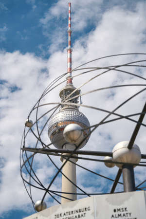 View of the television tower in Berlin. In the foreground parts of the world clock.の写真素材