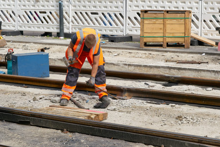 Berlin, Germany - September 15, 2021: a worker renewing old tracks of the tramway at Alexanderplatz...