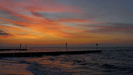 glowing sky after sunset on the beach of Kolobrzeg on the Polish Baltic coastの写真素材