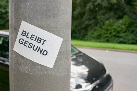 Sticker on a pillar in downtown Berlin during the corona pandemic. Translation: Stay healthy