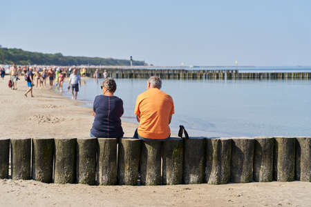 Kolobrzeg, Poland â September 09, 2021: Couple on a breakwater on the beach of Kolobrzeg on the Baltic Sea in Polandのeditorial素材
