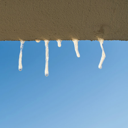 Icicles when looking out of the window of a house in winterの写真素材