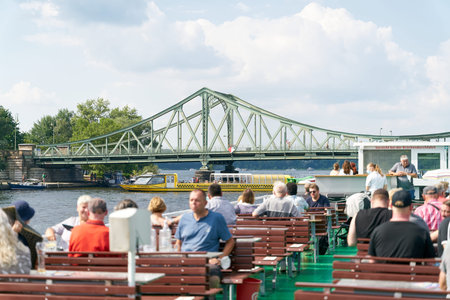 Berlin, Germany â July 17, 2021: Excursion boat on the Havel River at Glienicke Bridge between Berlin and Potsdam. The bridge was used during the Cold War for the exchange of agentsのeditorial素材
