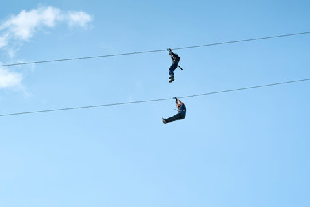 Magdeburg, Germany â April, 30, 2022: Two adventurous brave men on a zipline in Magdeburg in Germanyのeditorial素材