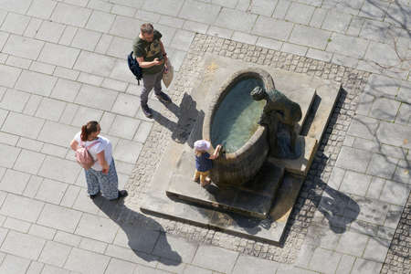 Magdeburg, Germany â April 29, 2022: Family with child seeks cooling at a fountain in the summer in the city center of Magdeburg in Germanyのeditorial素材