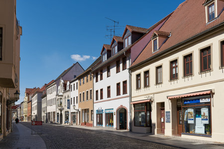 Wittenberg, Germany â€“ April 17, 2022: Street with some stores in the old town of Lutherstadt...