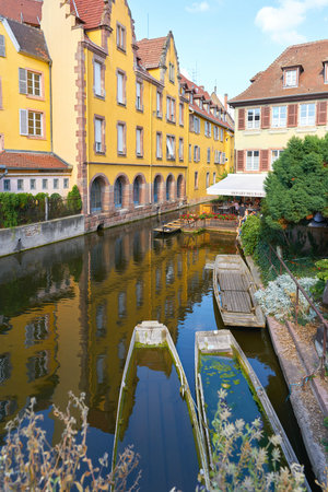 Colmar, France - August 28, 2022: The river Lauch with boats for tourists in the district of La Petite Venise in picturesque Colmar, Franceのeditorial素材