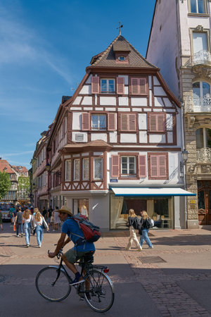 Colmar, France - September 02, 2022: Tourists and a cyclist in the picturesque old town of Colmar in Franceのeditorial素材