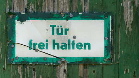 Sign on garage door with german inscription Keep door clear. Translation: keep door freeの写真素材