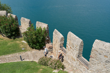 Malcesine, Italy â August 02, 2023: View from the tower of the Scaligerburg, Scaliger Castle on the shore of Lake Garda in Malcesine to the complex belowのeditorial素材