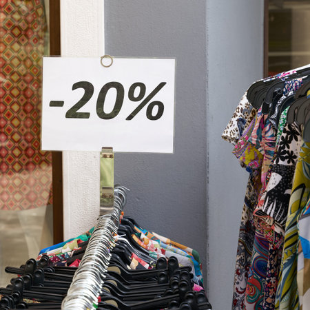 Notice of a 20 percent discount on clothing at a store in the old town of Riva del Garda in Italy