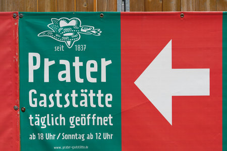 Berlin, Germany â May 30, 2023: Advertisement with directional arrow on a fence for the oldest beer garden in Berlin, the Prater in the district of Prenzlauer Bergのeditorial素材