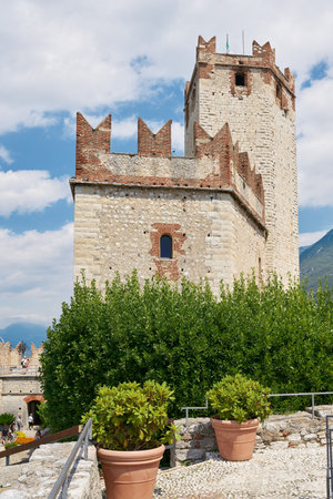 Malcesine, Italy - August 02, 2023: View of the medieval Scaligerburg, Scaliger Castle, Castello Scaligero from the old town in Malcesine on Lake Gardaのeditorial素材