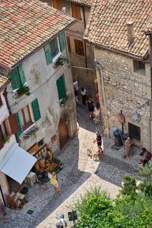 Malcesine, Italy â August 02, 2023: Old town of Malcesine on Lake Garda in Italy with some vacationers from a bird's eye viewのeditorial素材