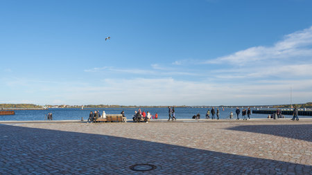 Stralsund, Germany â October 29, 2023: Tourists on the popular promenade in the harbor of Stralsund on the Strelasund in Germany in the sunshineのeditorial素材