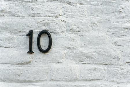 The house number 10 on the facade of a residential building in the old town of Bruges in Belgiumの写真素材