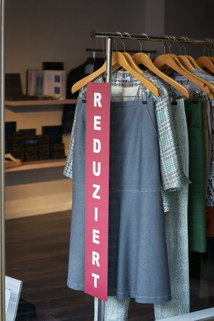 Sign with the German word Reduziert in the window of a second-hand store in Cologne in Germany....