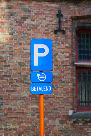Reference to a parking lot with a fee-based charging station for electric cars in the old town of Bruges in Belgiumの写真素材