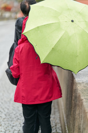 Tourists on the old Main Bridge, Alte MainbrÃ¼cke in Wuerzburg in rainy weather with umbrellasの写真素材