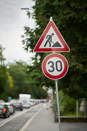Traffic signs indicating a speed limit at a roadworks site in Wuerzburg in Germanyの写真素材
