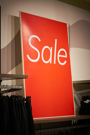Sign with the inscription Sale to indicate a special offer in a clothing storeの写真素材