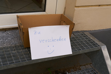 Sign with the German inscription to give away in the city center of Erfurt, Germany. Translation: to...
