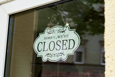 Sign in a shop window with the words Sorry, we are closed