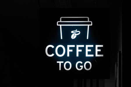 Neon sign at night at a cafÃ© in Italy with the words Coffee to goの写真素材