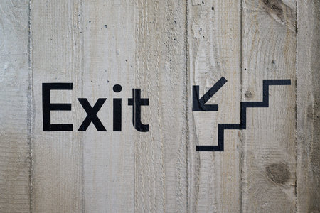 Exit lettering on a concrete wall in a public building indicating an escape route or exit