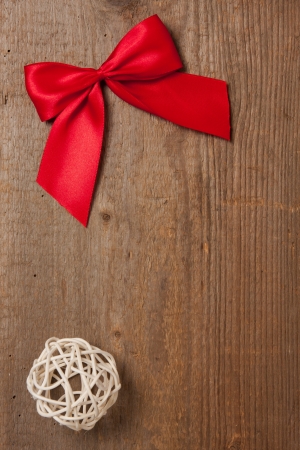 Wooden board with red ribbon and straw ballの写真素材