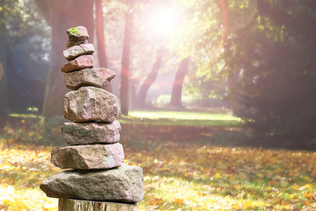 Stacked stone pyramid from sandstone in an autumnal parkの写真素材
